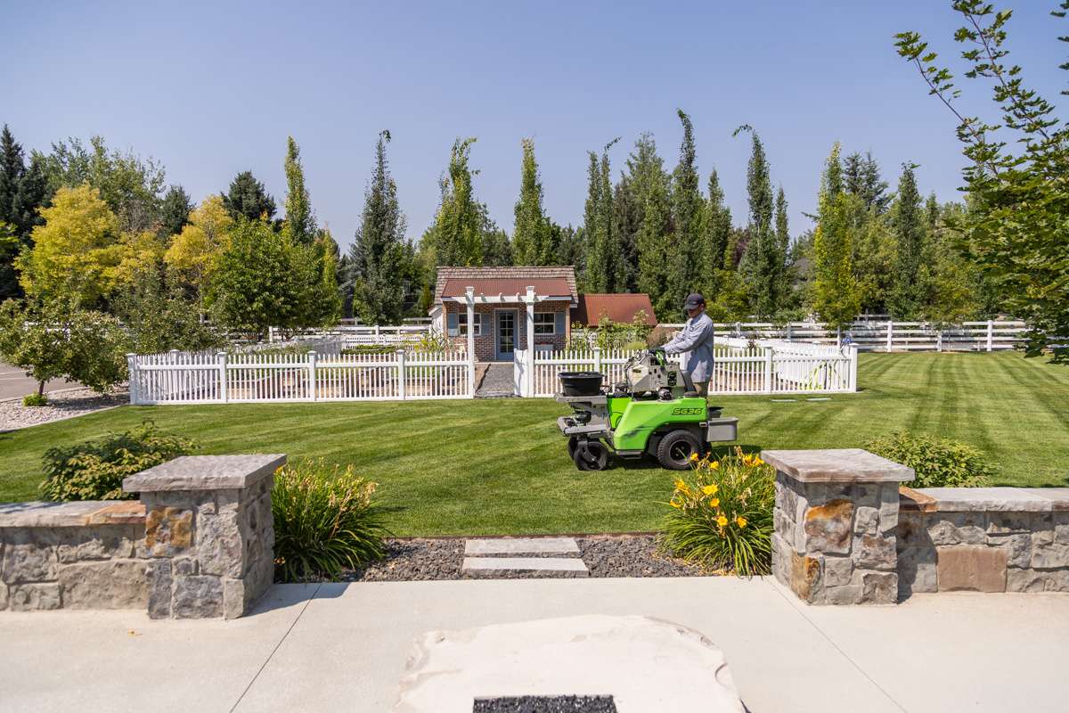 wall machine service action crew technician fence lawn grass turf trees shed
