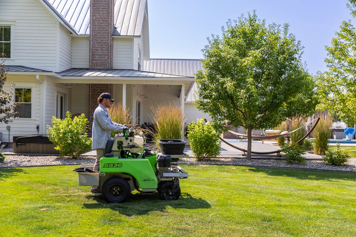 yard service action machine home house green turf lawn trees 2