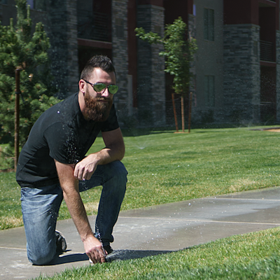 lawn care expert adjusts sprinkler head