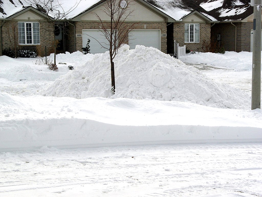 large pile of snow on lawn