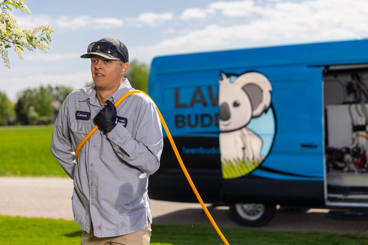 lawn care expert pulls hose out of van