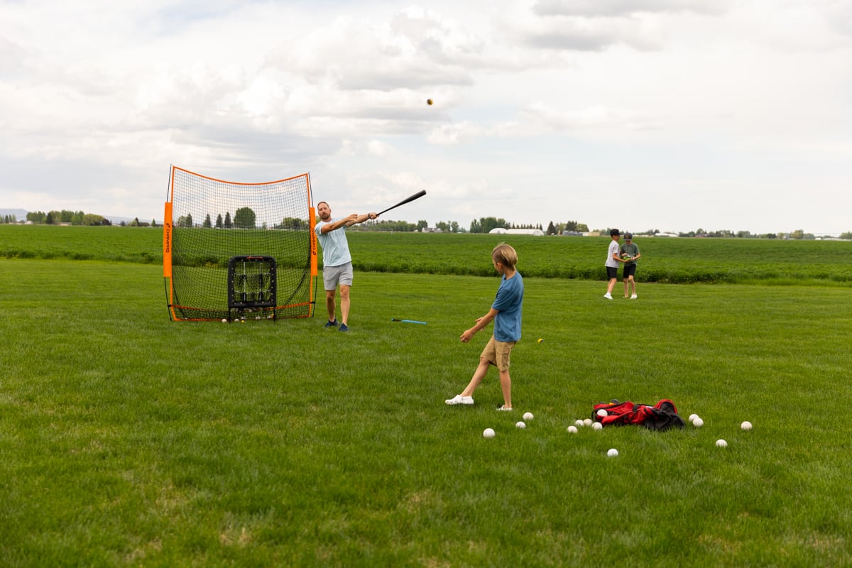 family plays baseball in healthy grass
