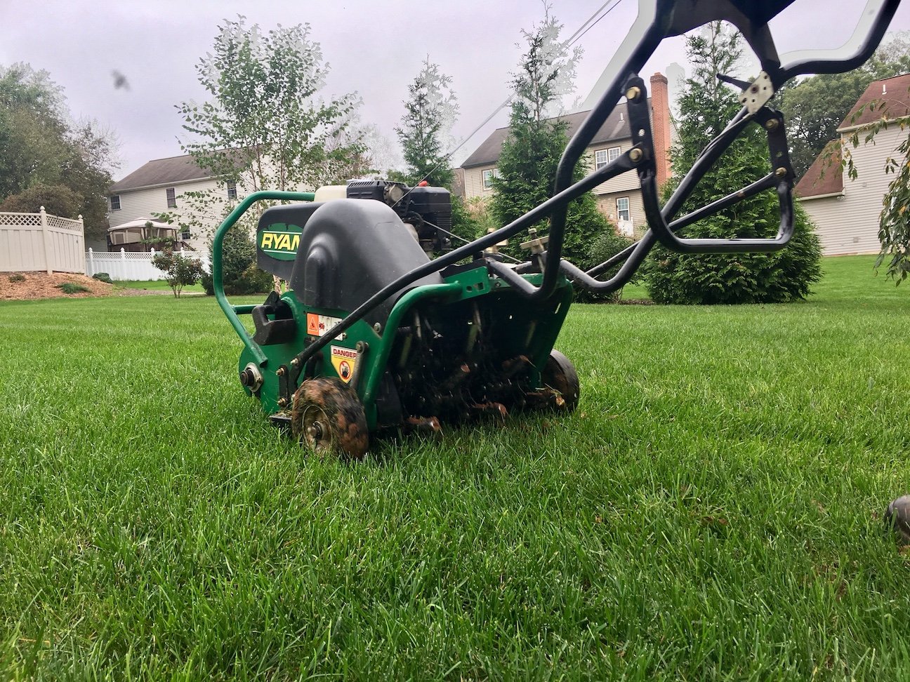 lawn being aerated with walk behind machine