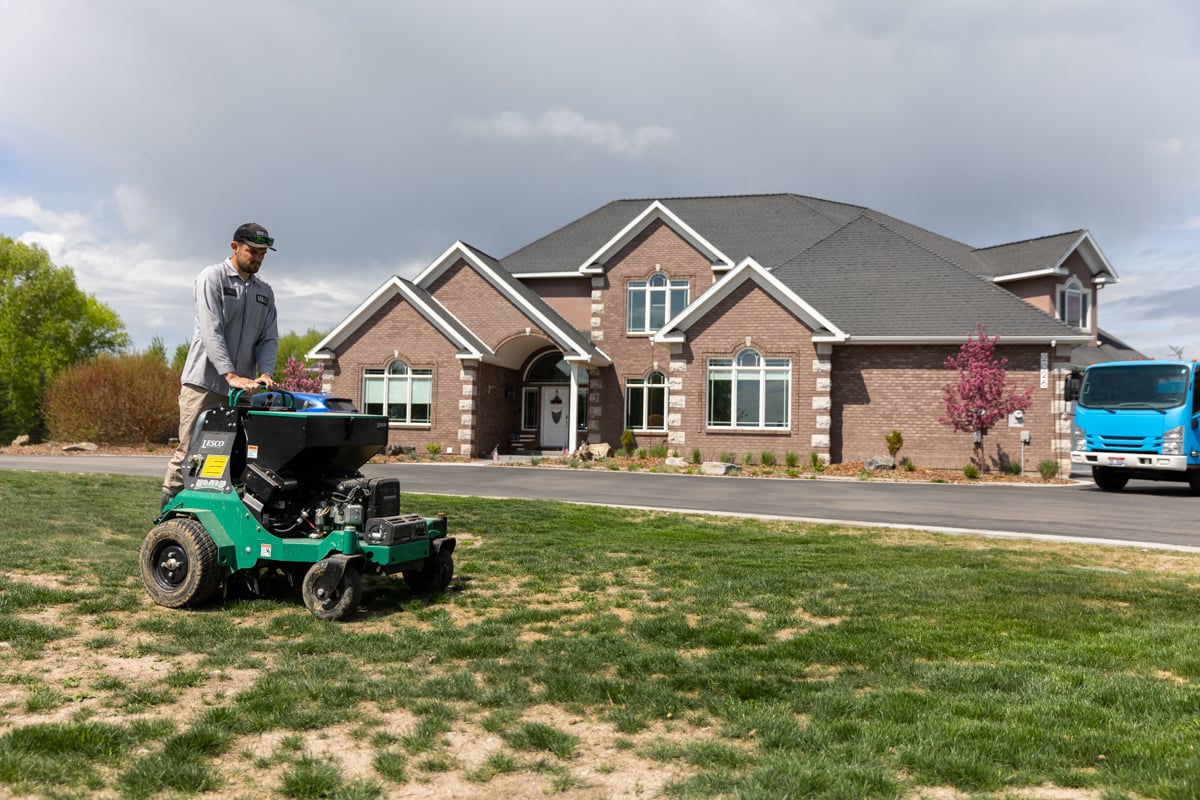 lawn care expert aerates grass
