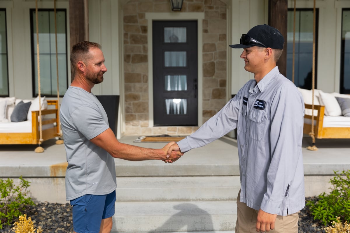 lawn care technician shakes hands