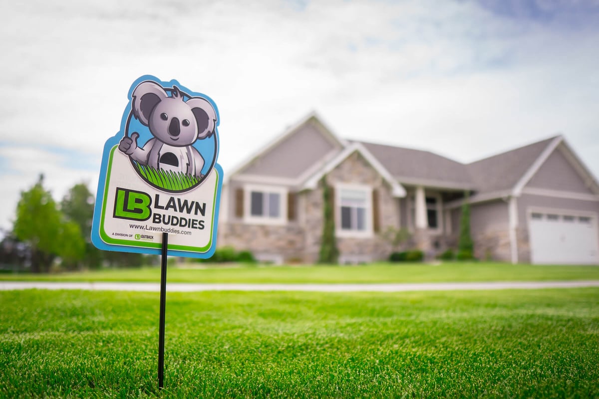 lawn with lawn buddies fertilization sign