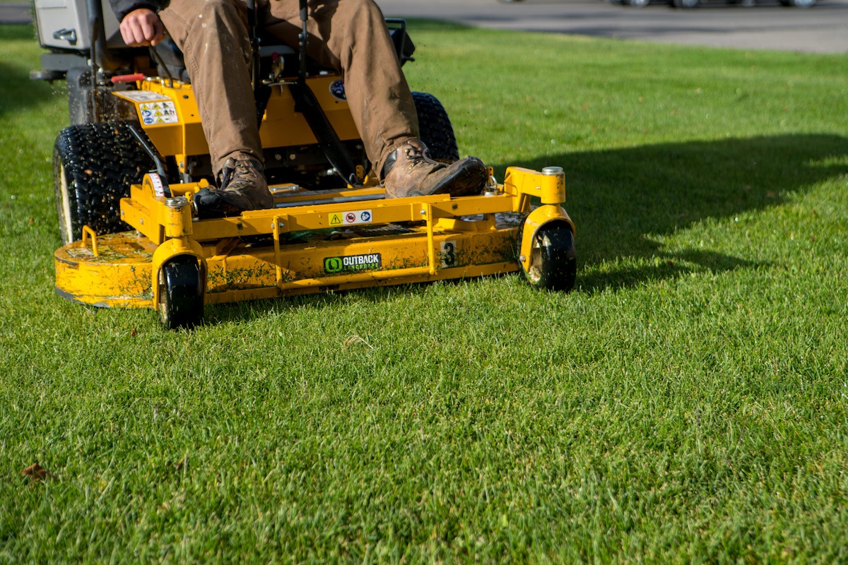 lawn maintenance team mowing lawn on ride-on mower