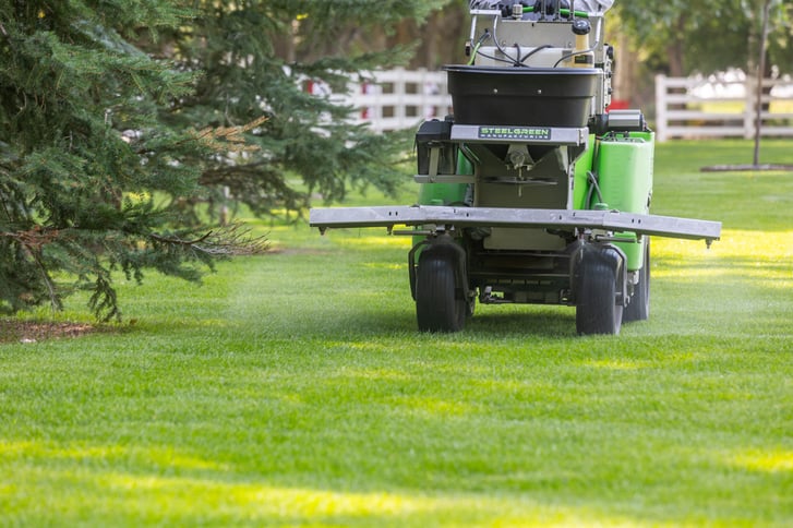 lawn care applying fertilizer to grass