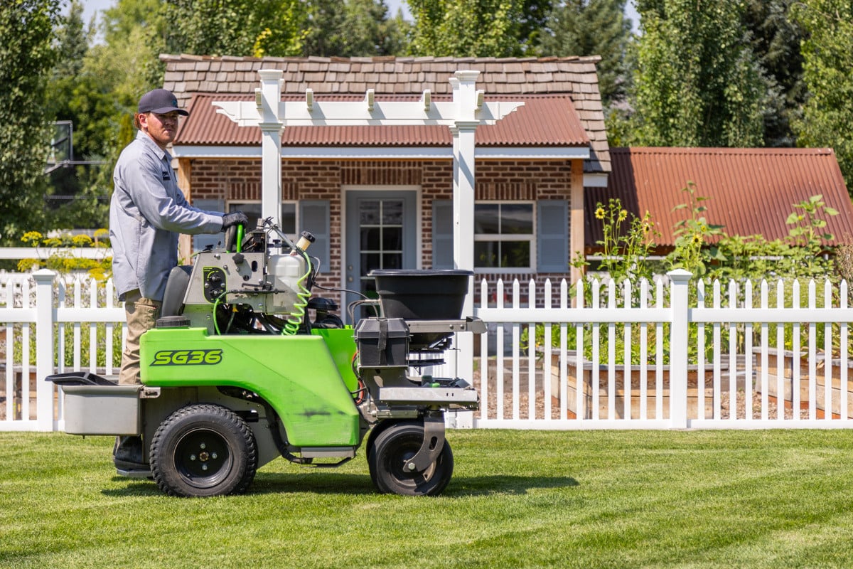 wall machine service action crew technician fence lawn grass turf trees shed 4