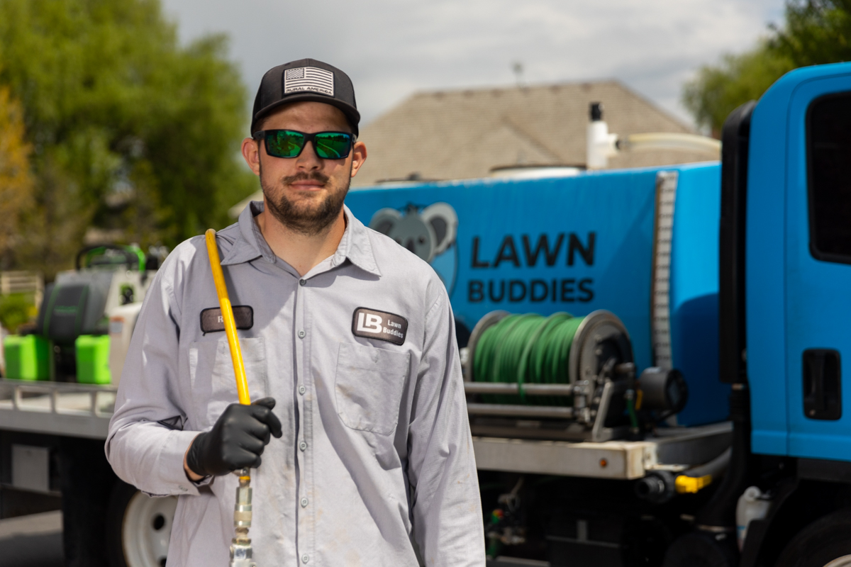 Lawn care team in front of truck