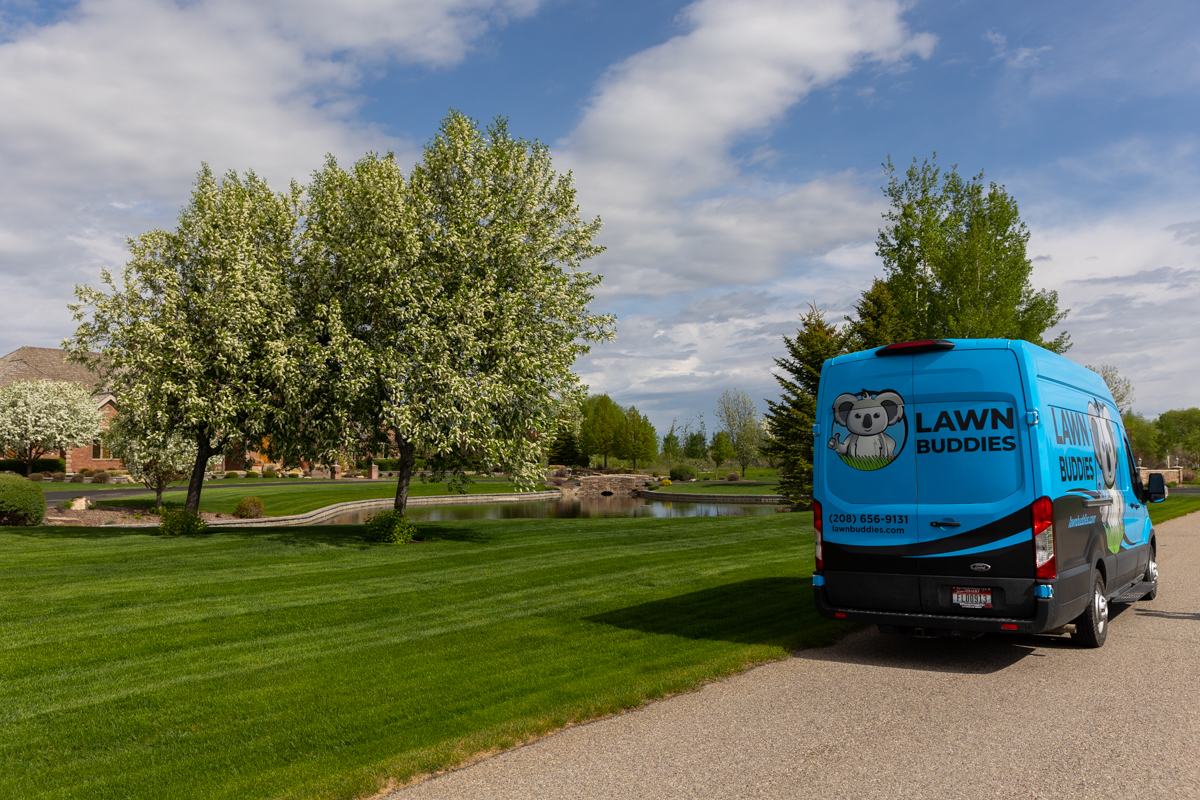 lawn care van in front of beautiful lawn